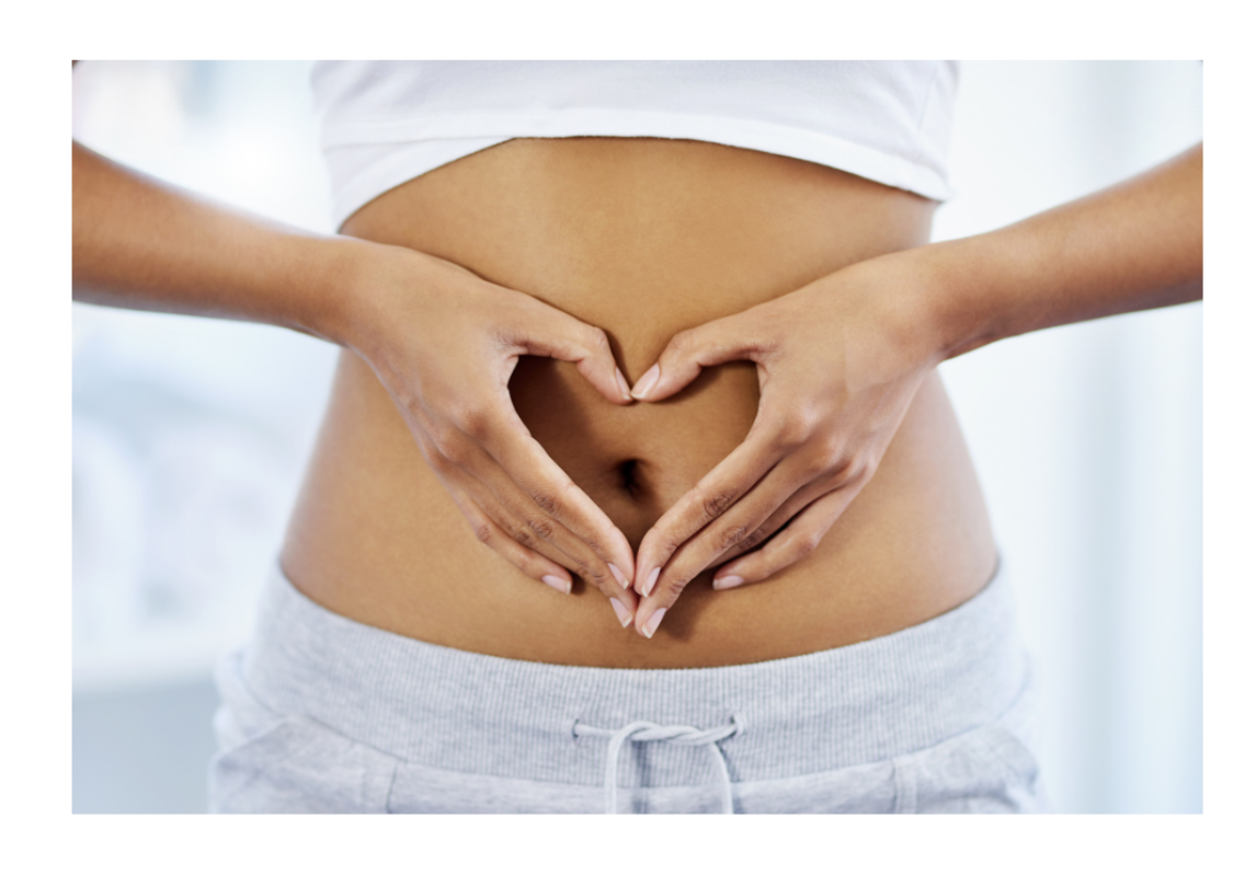 woman making a heart shape with her hands over her tummy